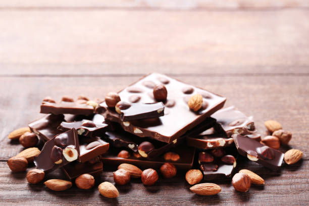 istock Chocolate pieces with nuts on wooden table 1011115626