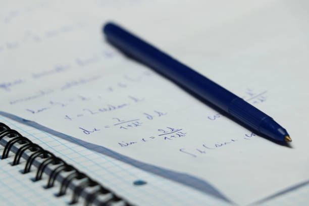 istock A blue pen with small exercise book and different make a calculation in math on university. A small iron circle attaching papers 1011125840