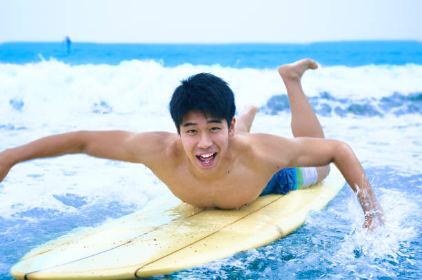 istock Young surfer on the wave before sunrise 1011137774