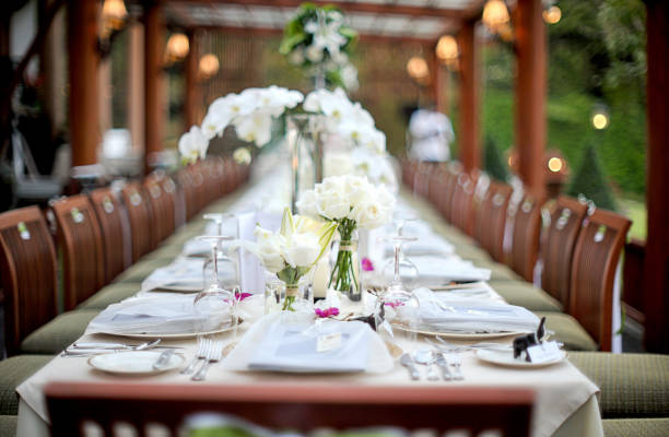 istock Wedding preparation restaurant and wedding planners.Chairs and honeymooners table decorated with candles, served with cutlery and crockery and covered with a table cloth. 1011141514