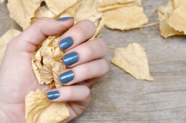 istock Female hand with blue nail design 1011146058
