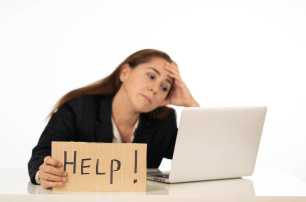 istock Young attractive latin woman showing help sign desperate suffering stress at work while sitting at office laptop computer desk in business overwork female feeling stressed and overwhelmed. 1011146644