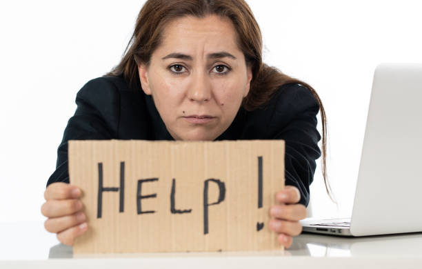 istock Sad businesswoman holding a help sign 1011146646