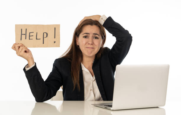 istock Young attractive latin woman showing help sign desperate suffering stress at work while sitting at office laptop computer desk in business overwork female feeling stressed and overwhelmed. 1011146862
