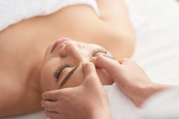 istock Close-up hands massaging face of client 1011160426