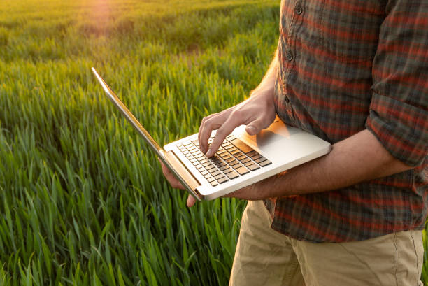 istock Young man using laptop outdoors 1011161324