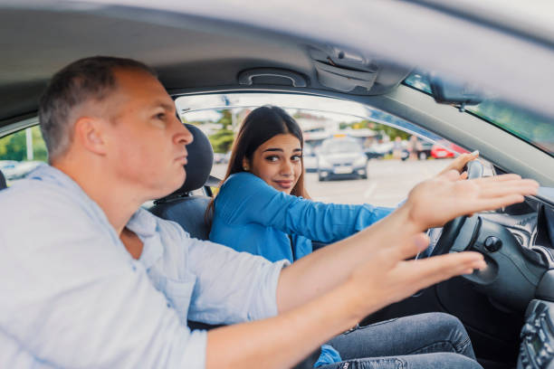 istock Woman getting a driving lesson in the car 1011166482