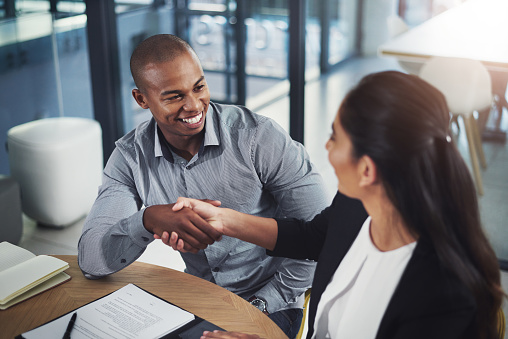 Shot of two businesspeople shaking hands in an office