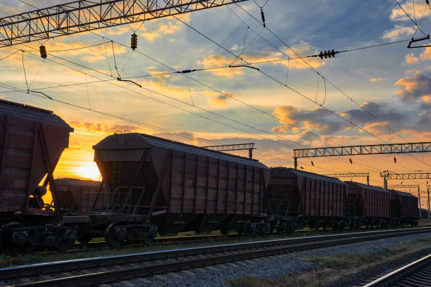 istock railroad infrastructure during beautiful sunset and colorful sky, railcar for dry cargo, transportation and industrial concept 1011173014