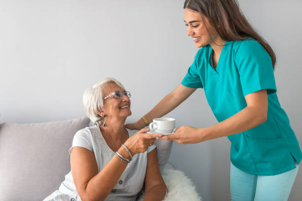 istock Happy patient is holding caregiver for a hand while spending time together 1011176232