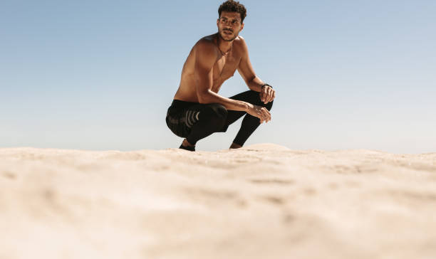 istock Man relaxing after workout on the beach 1011181014