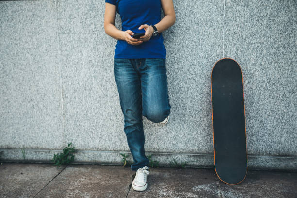 istock one skateboarder use mobile phone on city 1011181144