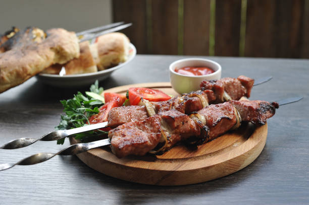 istock pork kebab on skewers with vegetables and herbs 1011181690