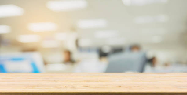 istock wood table desk with abstract blur office interior business background 1011181702