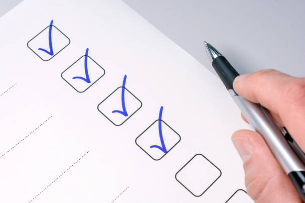 Background of a checklist with checked tasks and a pen-holding hand checklist task stock pictures, royalty-free photos & images