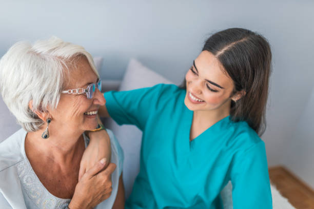 istock Nurse caring for elderly woman in light room 1011184598