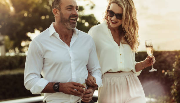 beautiful couple with a glass of wine outdoors - snob imagens e fotografias de stock