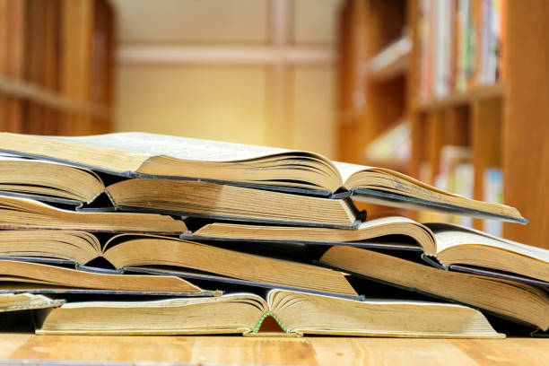 istock Many books are opened overlapping. Put on the table in the library. 1011190130