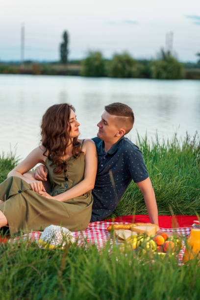 istock Beautiful young couple on picnic near river 1011191004