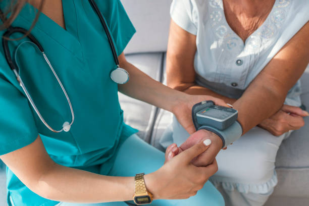 istock Delighted nurse measuring blood pressure 1011191060