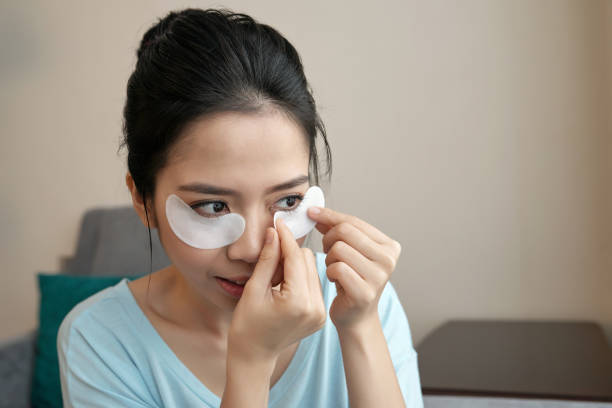 istock Asian woman applying under-eye pads 1011197018