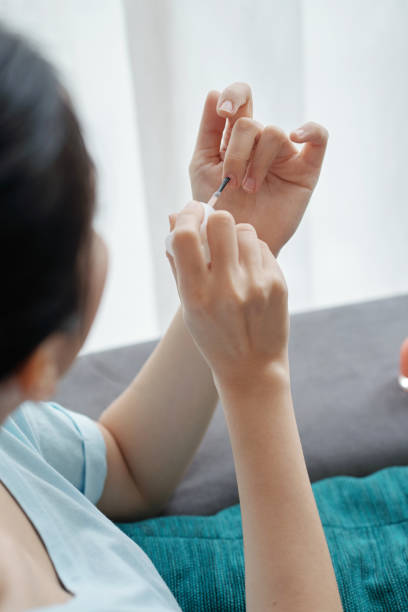 istock Anonymous lady painting nails 1011197094