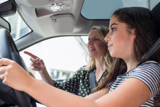 Teenager Having Driving Lesson With Female Instructor Teenager Having Driving Lesson With Female Instructor driving test photos stock pictures, royalty-free photos & images