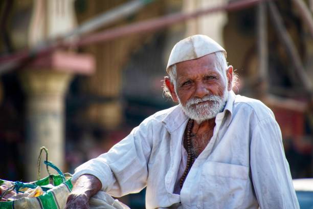 Pune, India - April 28 2018: Old man with beard poses outdoors at Alandi Temple near Pune India.