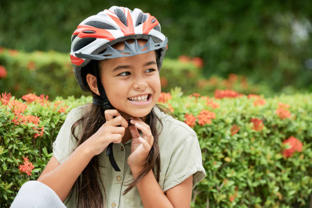 istock Cheerful Asian girl putting on helmet 1011214630