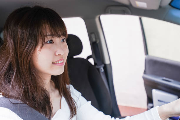 istock Young woman driving a car 1011216860