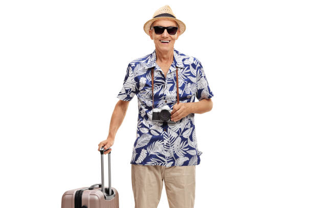 istock Elderly tourist with a suitcase and a camera 1011232036