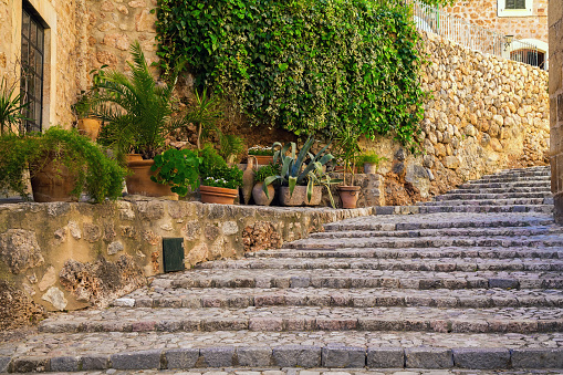 classical view with stone staircase on the street of Fornalutx village, Majorca, Spain