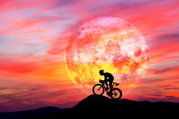 istock Bike rider with moon 1011236802