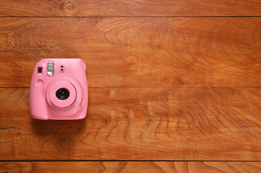 Instant Camera on Wood Table