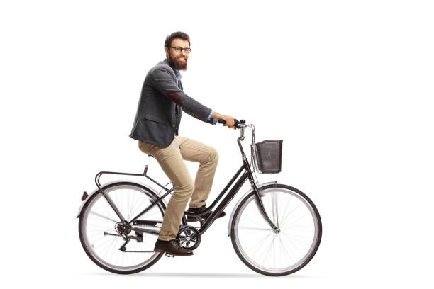 istock Bearded guy riding a bicycle and looking at the camera 1011236914