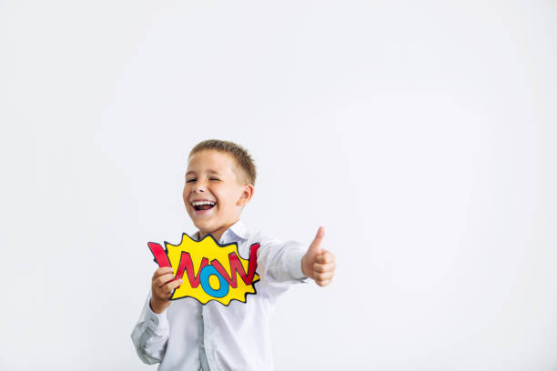 Beautiful child schoolboy in classroom at school on white background with wow from comic happy portrait with concept