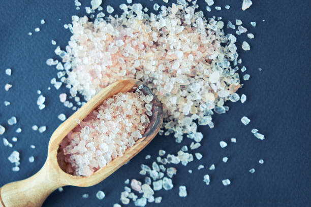 istock bowl of pink himalayan salt on dark table, top view, copy space 1011245218