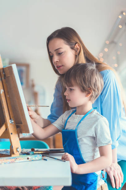 istock Teacher and pupil in the art workshop 1011245810