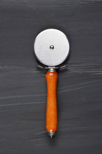 Pizza Cutter on Black Wood