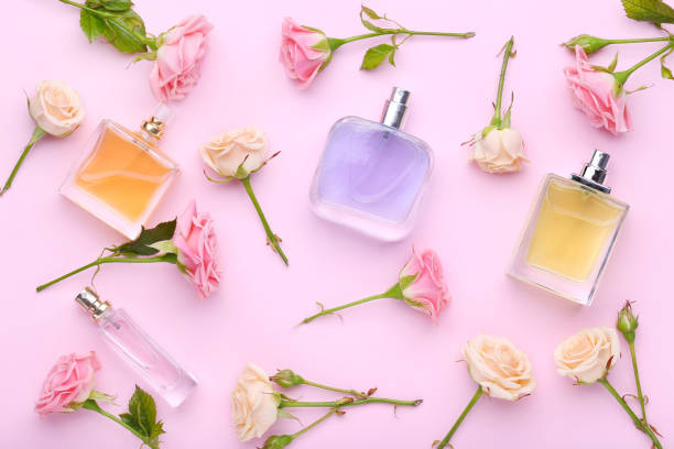 istock Perfume bottles with flowers on pink background 1011251266