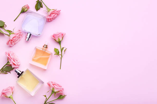 istock Perfume bottles with flowers on pink background 1011251362