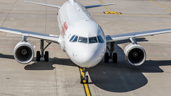 Zurich, Switzerland - June 12, 2018: After landing, an Airbus A320 from Swiss International Airlines rolls onto runway 14 to a gate at Terminal B. The aircraft was delivered to Swissair on 24 March 1998. However, this ceased operations in 2002. Since March 31, 2002, the aircraft with the registration HB-IJS belongs to the fleet of Swiss International Airlines. The picture was taken from the observation deck of Terminal B.