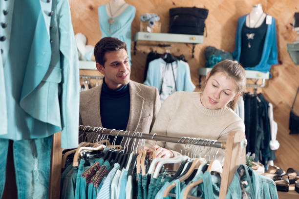 istock Couple is choosing jeans clothes for her 1011263928