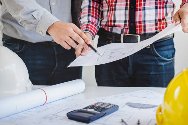 istock Architect or Engineer meeting working with partner on blueprint for architectural project in progress, construction and structure concept 1011264198