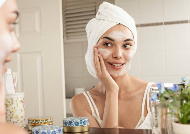 woman skincare at the bathroom woman beauty care at bathroom face cream stock pictures, royalty-free photos & images