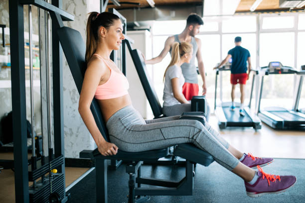 istock Woman working out in gym on machine 1011264444