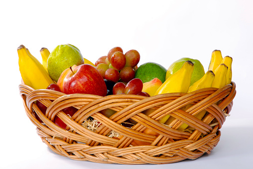 basket of fruit with banana, apple, grape, pear