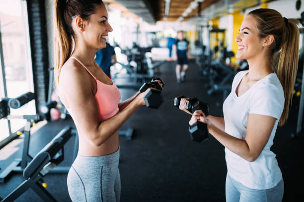 istock Young women doing exercises in gym together 1011266604