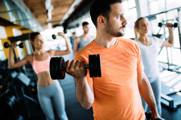 istock Fit man exercising at the gym on a machine 1011267126