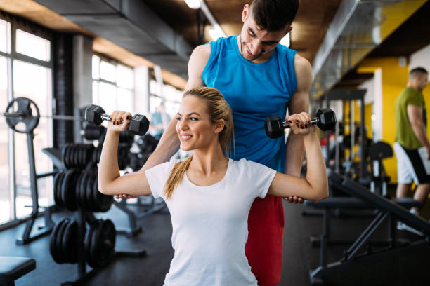istock Beautiful woman helped by trainer 1011268026